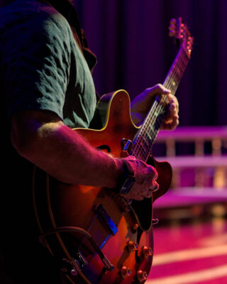 Live performance photography of musicians on stage in Washington Concert photography capturing stage lighting and live music performance Backstage rehearsal photography of performing artists Professional performance photography for theatre and touring musicians Documentary photography of artists and live entertainment