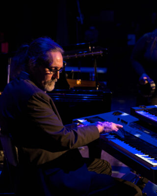 Live performance photography of musicians on stage in Washington Concert photography capturing stage lighting and live music performance Backstage rehearsal photography of performing artists Professional performance photography for theatre and touring musicians Documentary photography of artists and live entertainment